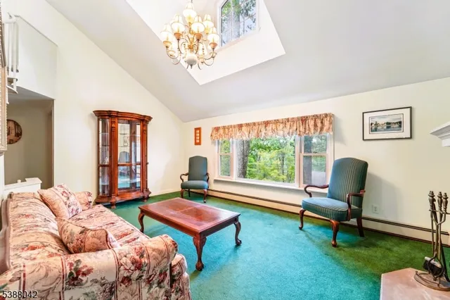 a living room with furniture a table and a large window