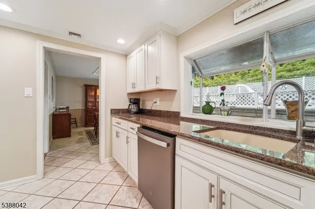 a kitchen with a sink cabinets and window