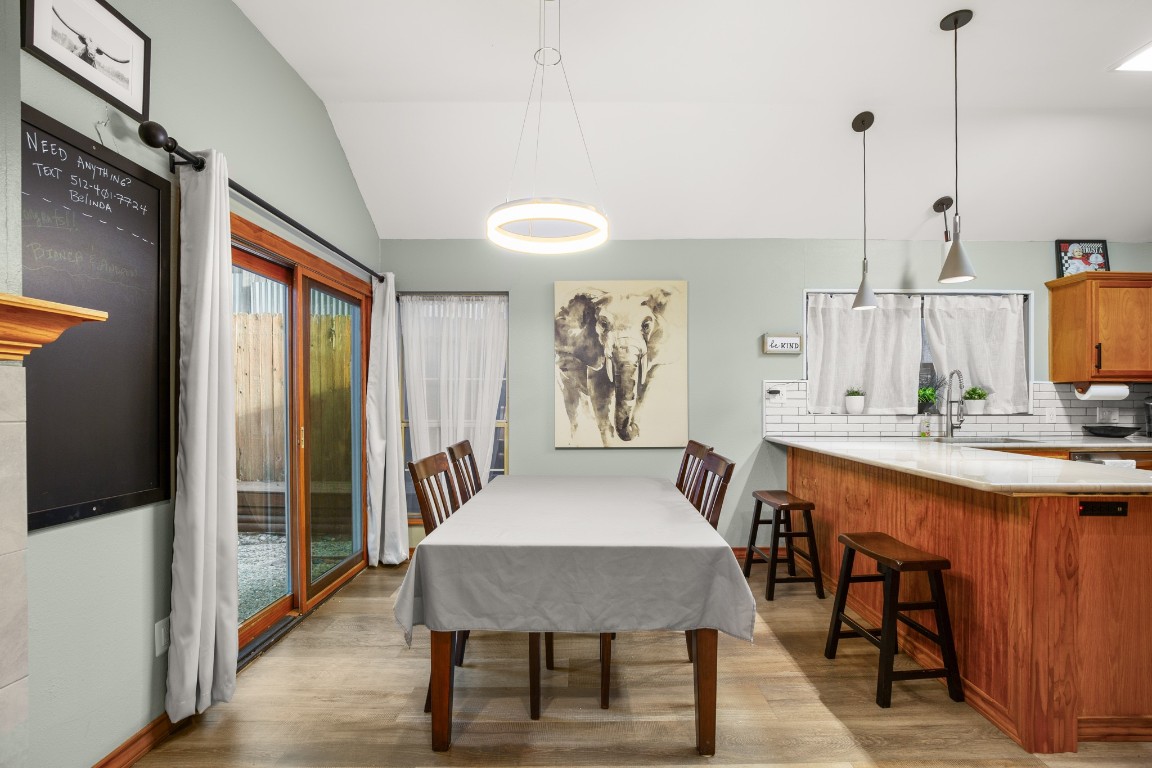 3015 Sunridge Drive Austin, TX 78741 - Photo 12 of 35 Dining room with light wood finished floors,
baseboards, and lofted ceiling