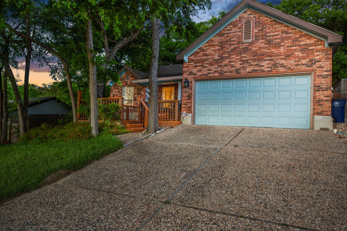 3015 Sunridge Drive Austin, TX 78741 - Photo 35 of 35 View of front of property with an attached garage,
driveway, and brick siding