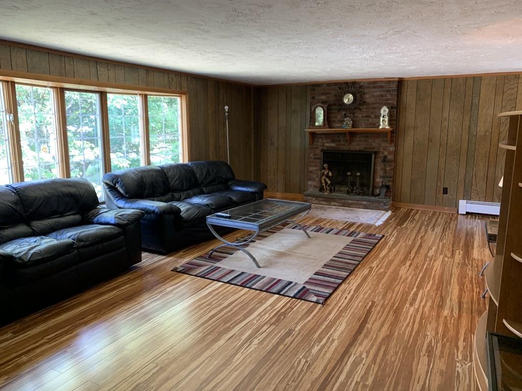 630 Wareham Street Middleboro, MA 02346 - Photo 2 of 10 a living room with furniture and a fireplace
