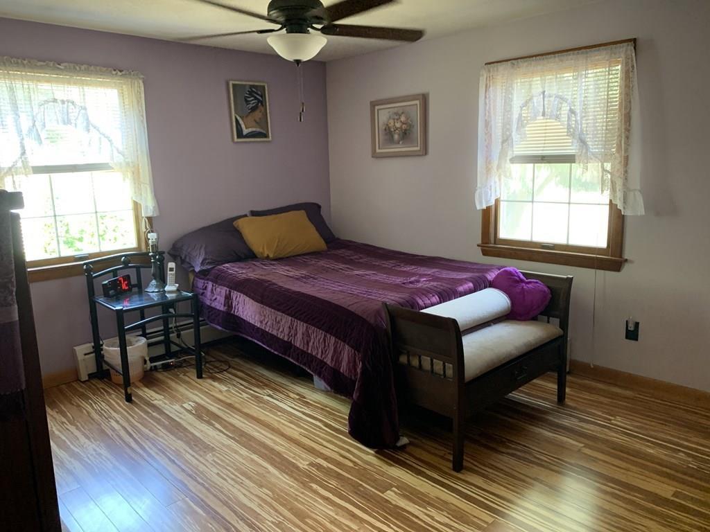 630 Wareham Street Middleboro, MA 02346 - Photo 7 of 10 a bedroom with a bed and wooden floor