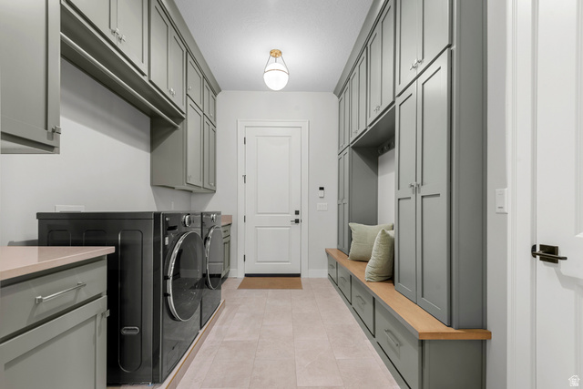 250 South Main Street, Unit 24 Alpine, UT 84004 - Photo 23 of 50 Laundry area with washing machine and clothes dryer, light tile patterned floors, and cabinet space