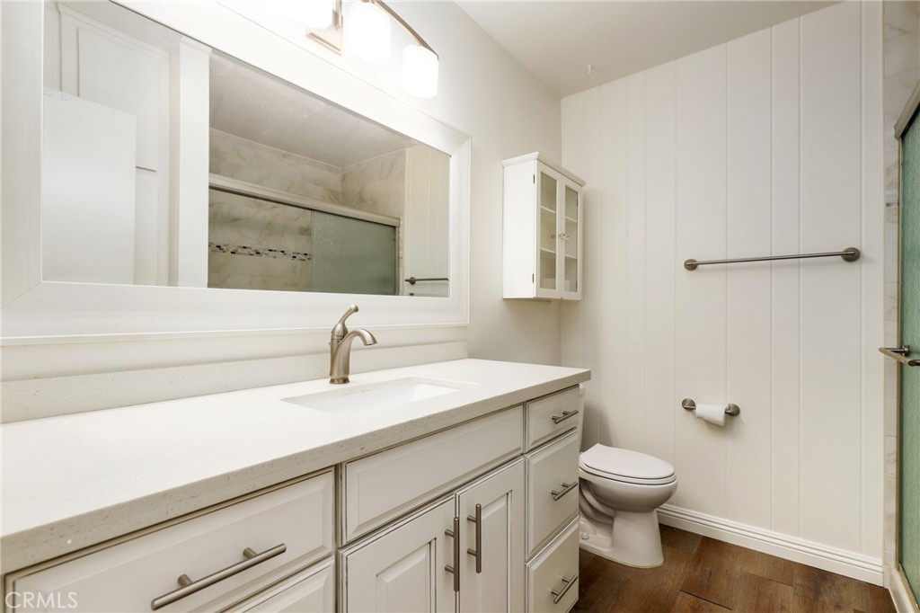 12200 Montecito Road, Unit D301 Seal Beach, CA 90740 - Photo 15 of 28 a bathroom with a sink a toilet and mirror