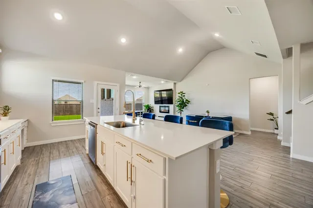 a large white kitchen with a large window