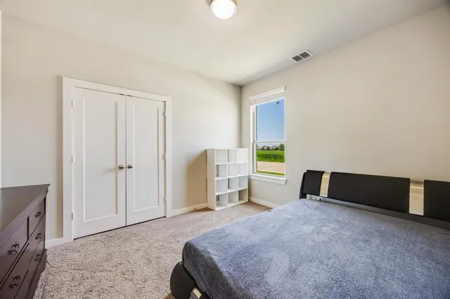 a bedroom with a bed and a cabinets