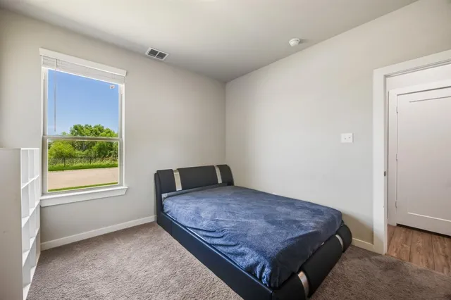 a bedroom with a bed and window