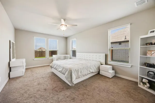 a spacious bedroom with a bed and a window