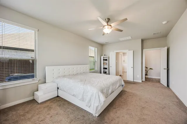 a bedroom with a large bed and a chandelier