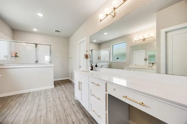 a spacious bathroom with a granite countertop sink mirror and toilet
