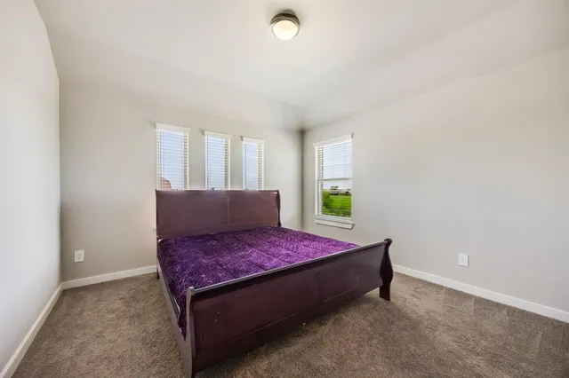 a bed room with a bed and a window