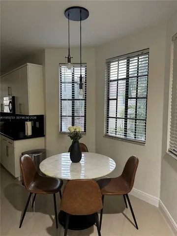 a view of a dining room with furniture and window