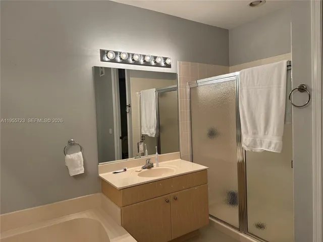 a bathroom with a sink a mirror and shower