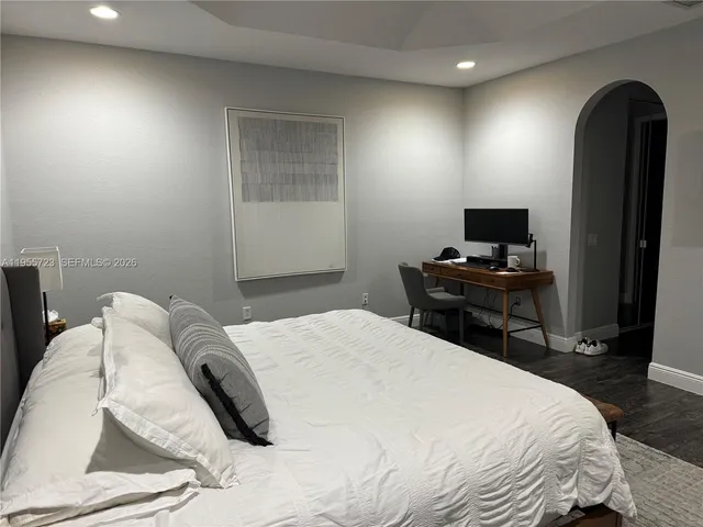 a bedroom with a bed and a flat screen tv