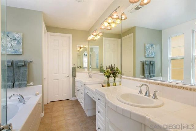 a spacious bathroom with a granite countertop sink mirror and shower