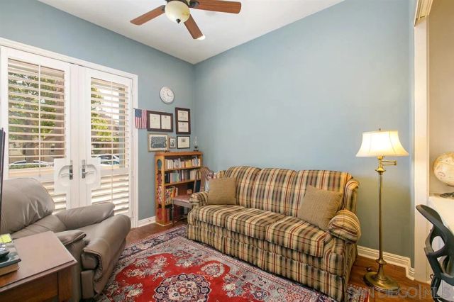a bedroom with furniture and a large window