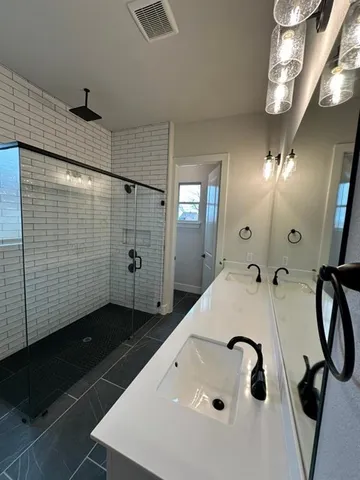 a bathroom with a tub sink and mirror