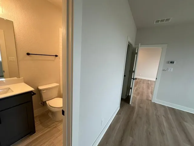 a bathroom with a granite countertop sink toilet and shower