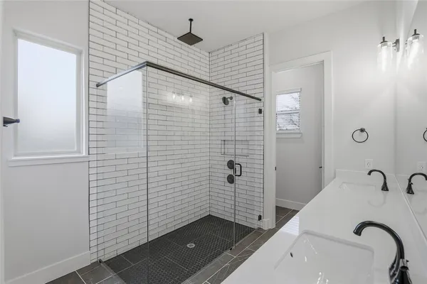 a bathroom with a sink and shower