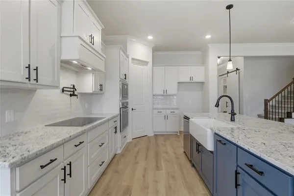 a bathroom with a granite countertop double vanity sink and mirror