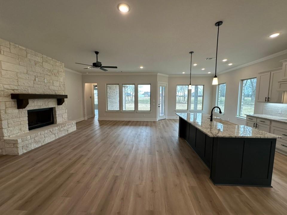 330 Cobb Road Leonard, TX 75452 - Photo 8 of 26 Kitchen featuring dark cabinetry, white cabinetry, ornamental molding, decorative light fixtures, and light wood-type flooring