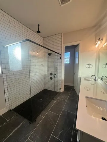 a bathroom with a shower and a sink