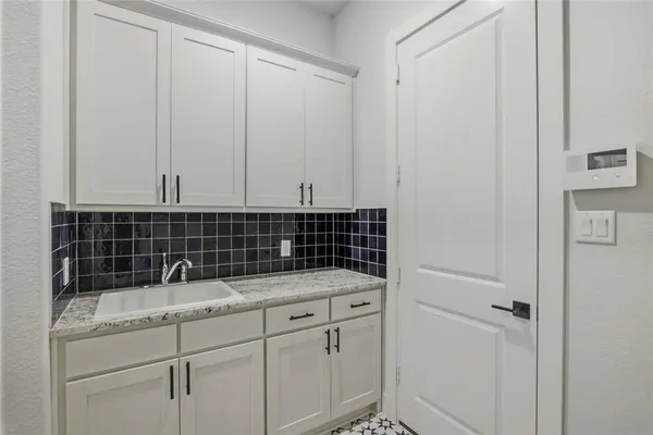 a bathroom with a granite countertop white sink and a mirror