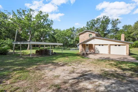 a view of a house with yard and a garden