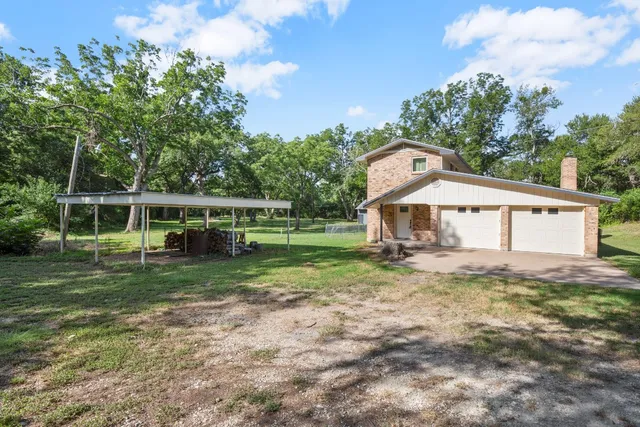 a view of a house with yard and a garden