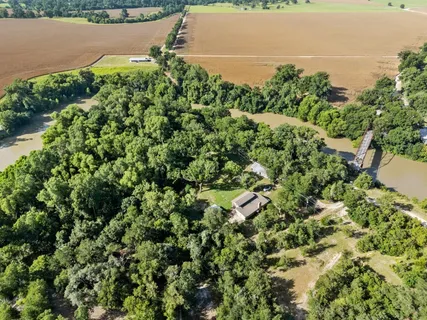 an aerial view of a houses with a lake view
