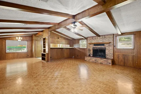 an empty room with furniture and a fireplace