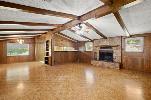 an empty room with furniture and a fireplace