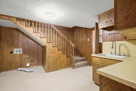 a view of a kitchen with a sink and cabinets