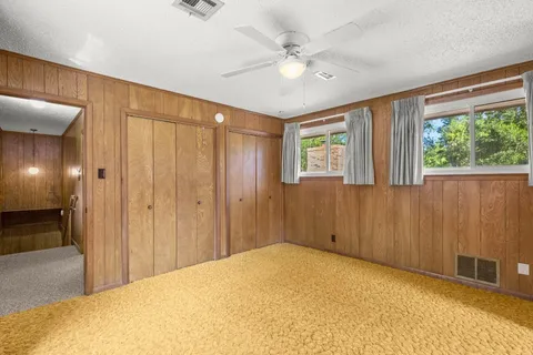 a view of a livingroom with a ceiling fan and window