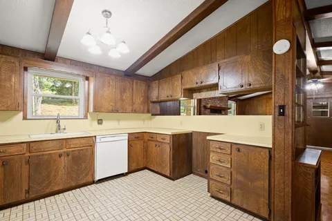 a kitchen with stainless steel appliances granite countertop a sink a stove and refrigerator