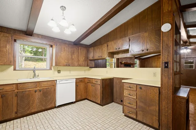 a kitchen with stainless steel appliances granite countertop a sink a stove and refrigerator