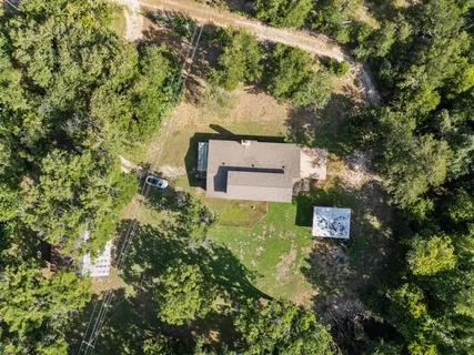 an aerial view of a house with a yard