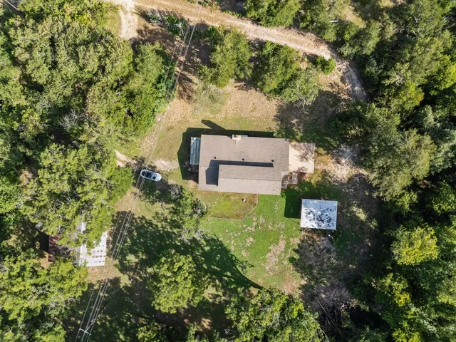 an aerial view of a house with a yard
