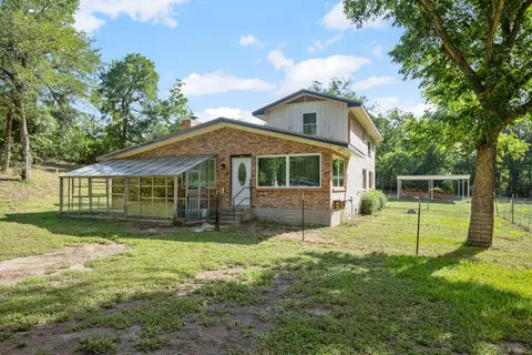 a view of house with a yard