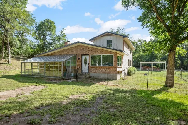 a view of house with a yard