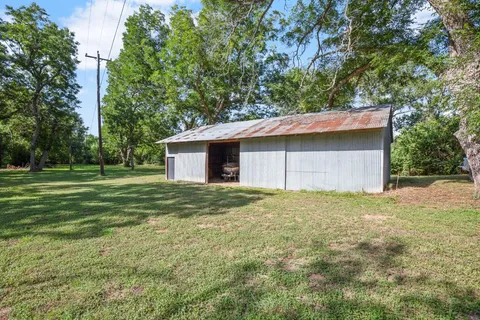 a house with huge green field in front of it