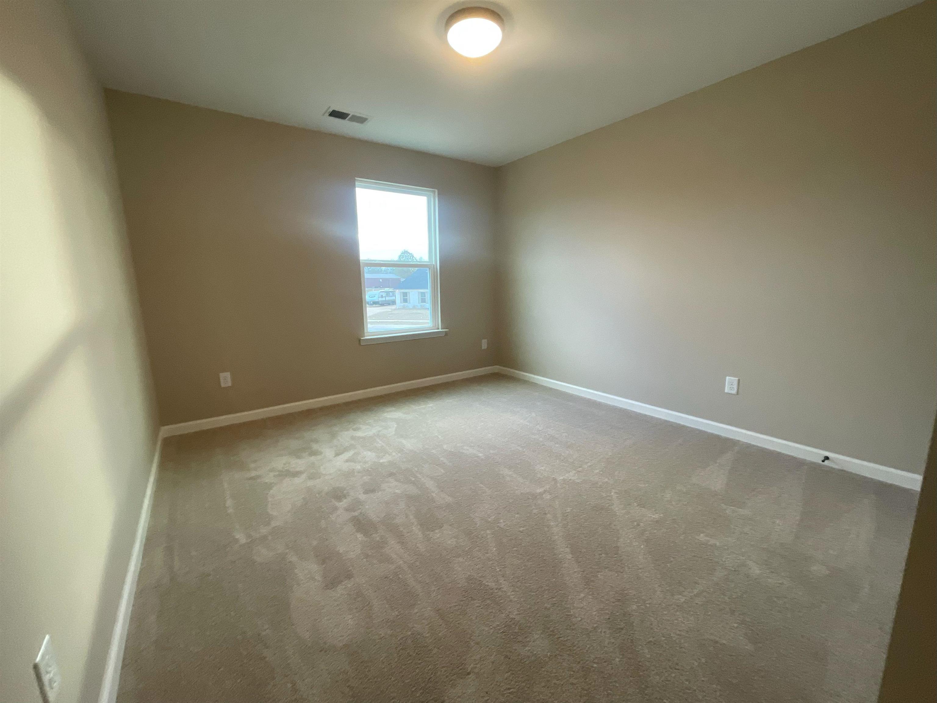 170 Como Lane Atoka, TN 38004 - Photo 12 of 27 Unfurnished room with baseboards and light carpet