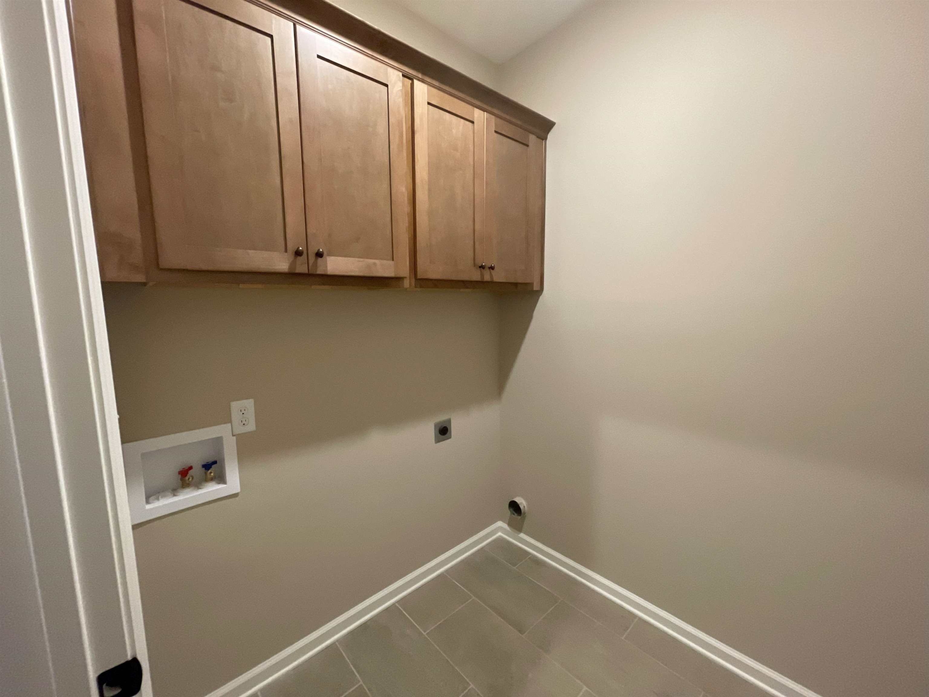 170 Como Lane Atoka, TN 38004 - Photo 14 of 27 Laundry room with cabinet space, tile patterned floors, hookup for a washing machine, and electric dryer hookup