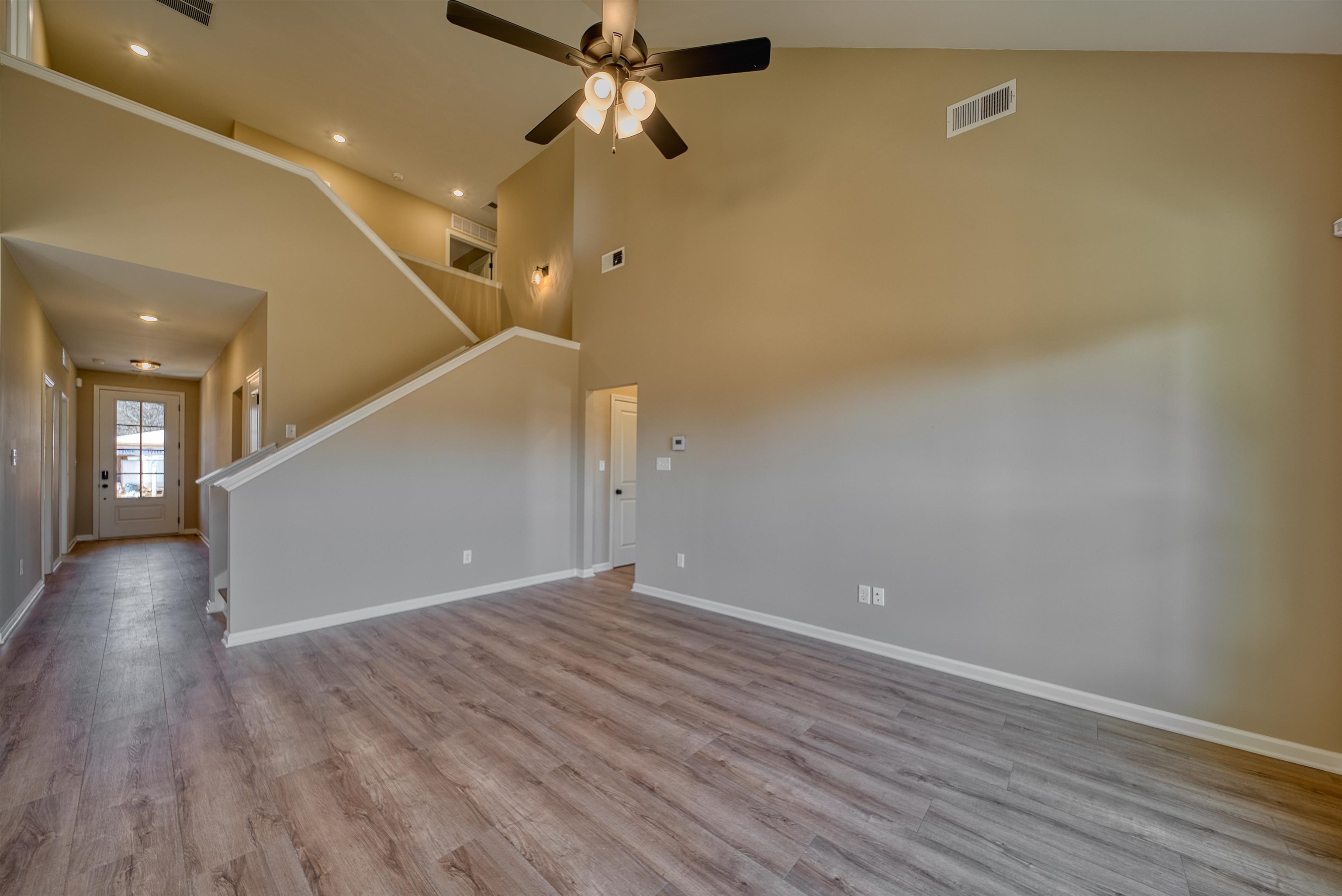 170 Como Lane Atoka, TN 38004 - Photo 18 of 40 Unfurnished living room featuring light wood-style floors, a ceiling fan, recessed lighting, and lofted ceiling