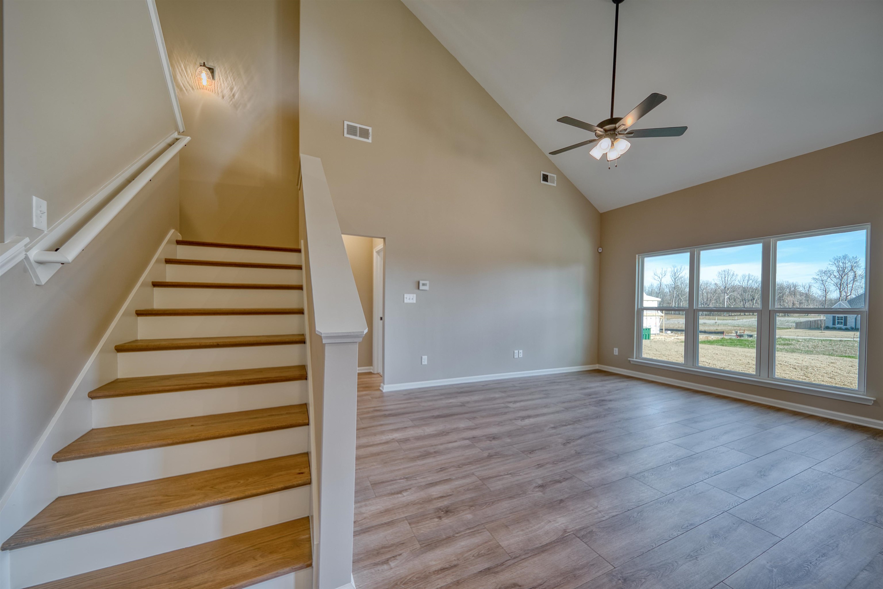 170 Como Lane Atoka, TN 38004 - Photo 24 of 40 Stairs featuring a high ceiling, wood finished floors, and ceiling fan