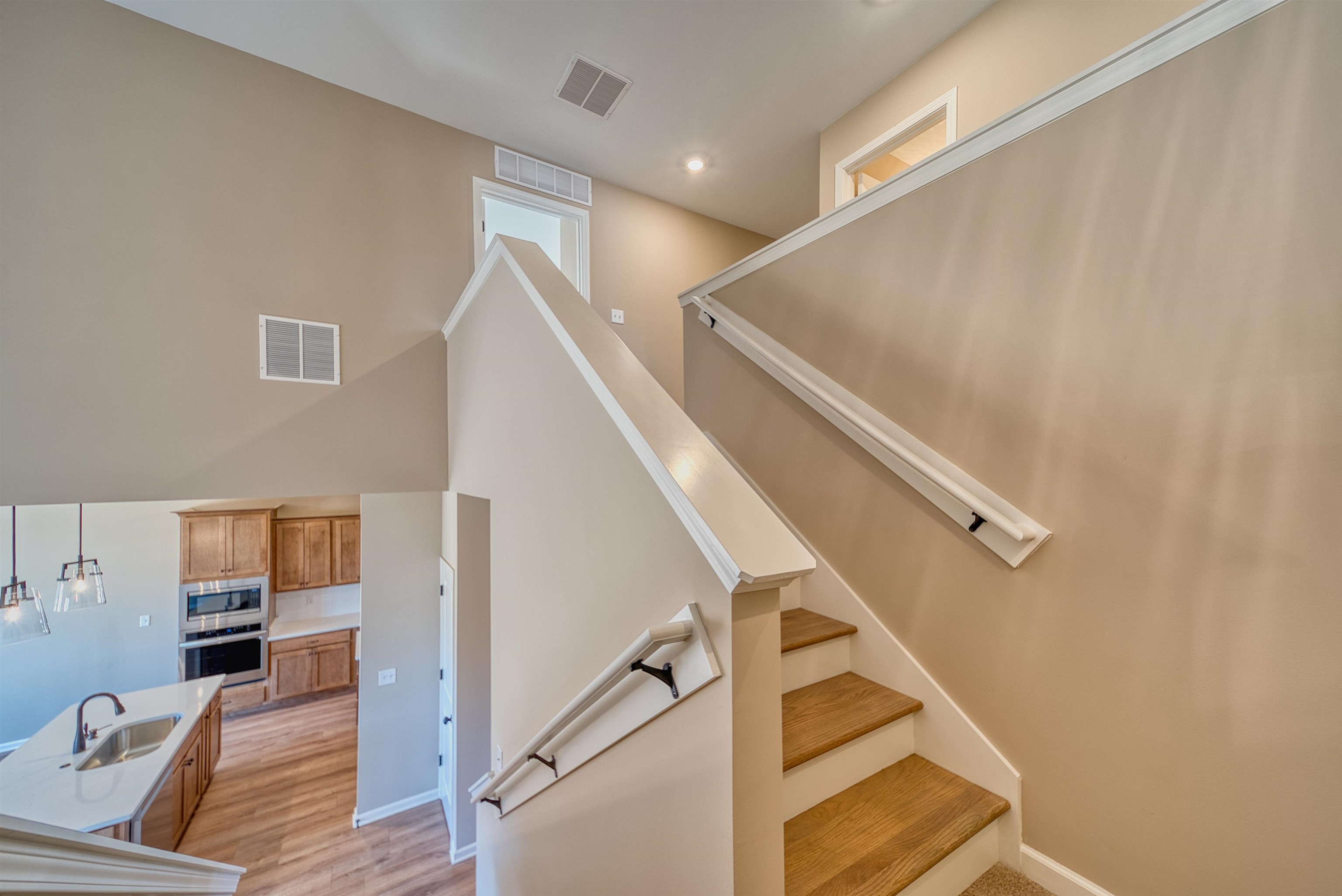 170 Como Lane Atoka, TN 38004 - Photo 25 of 40 Stairway with wood finished floors and a high ceiling