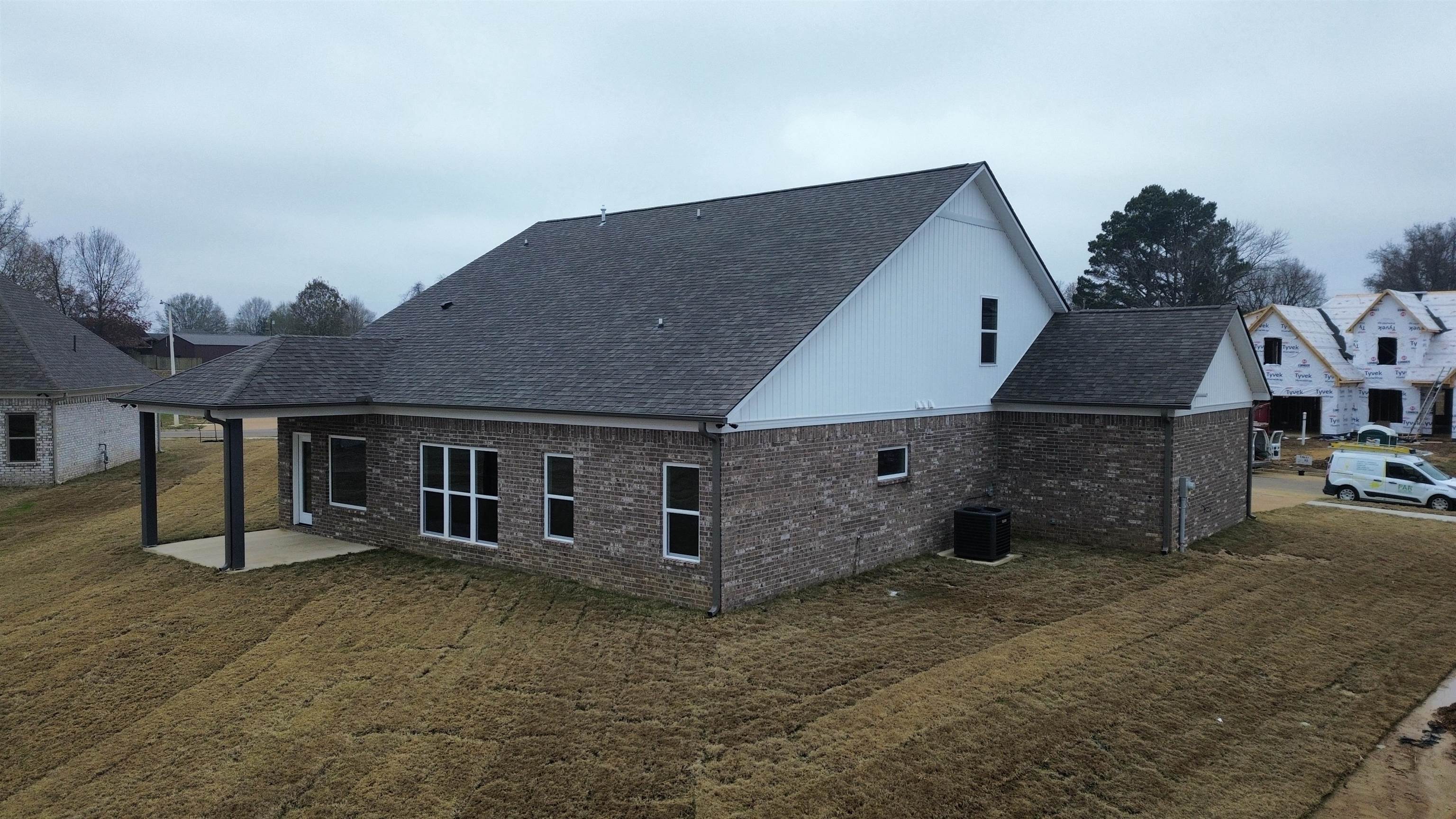 170 Como Lane Atoka, TN 38004 - Photo 26 of 27 Rear view of property with brick siding, roof with shingles, a patio area, and a lawn