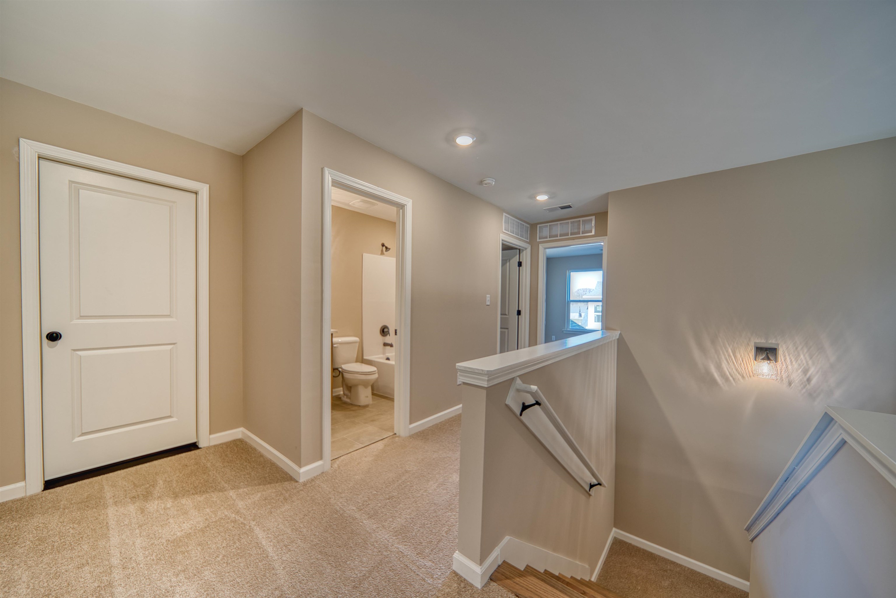 170 Como Lane Atoka, TN 38004 - Photo 27 of 40 Hallway with an upstairs landing and light carpet