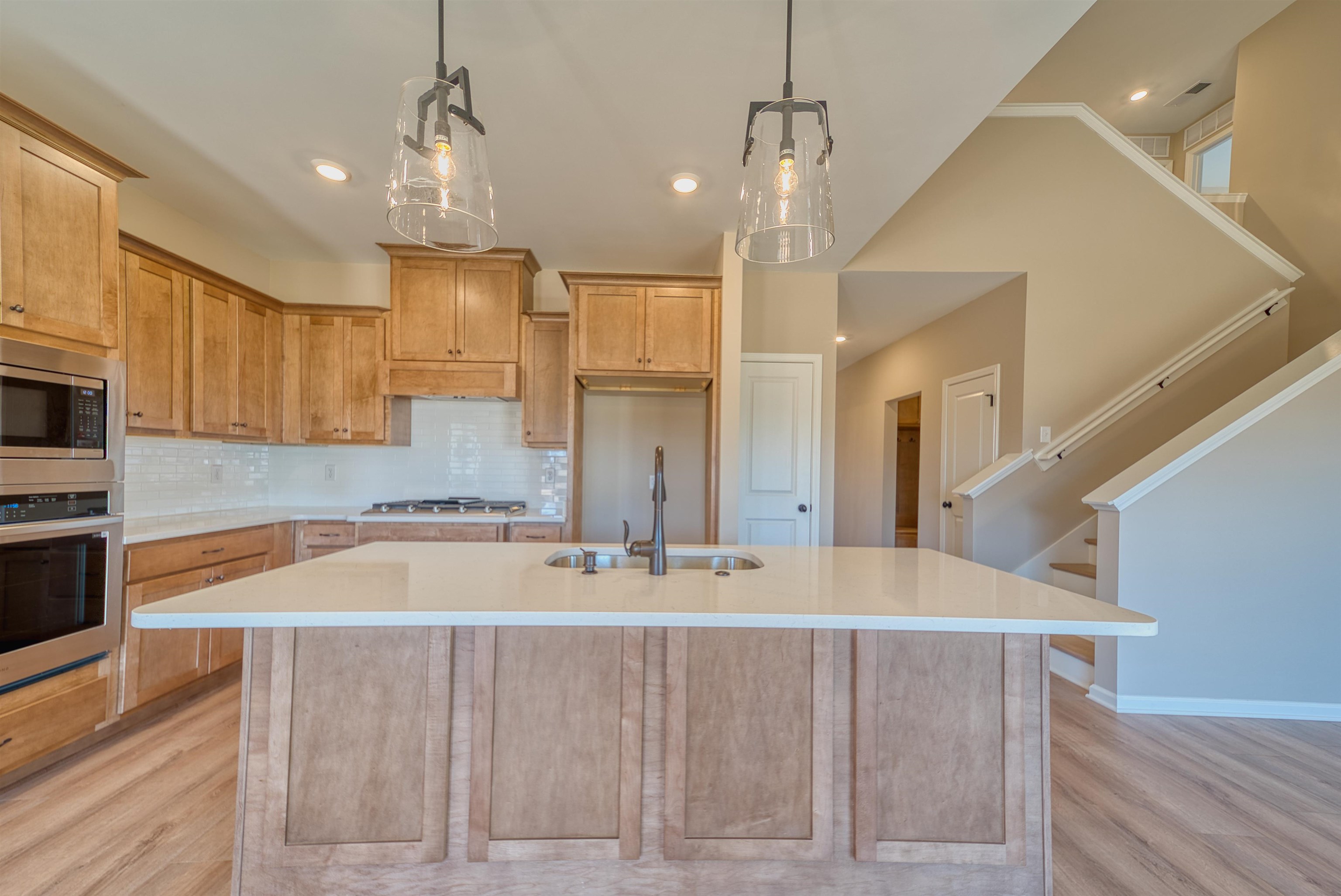 170 Como Lane Atoka, TN 38004 - Photo 3 of 40 Kitchen with backsplash, stainless steel appliances, a center island with sink, and light wood-type flooring