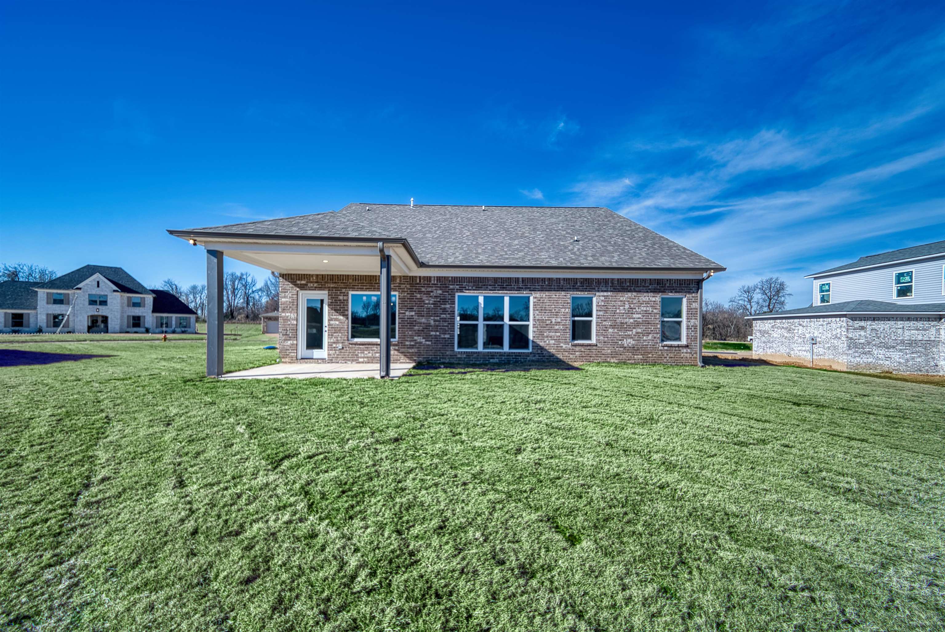 170 Como Lane Atoka, TN 38004 - Photo 39 of 40 Rear view of property featuring a patio area, brick siding, a shingled roof, and a lawn